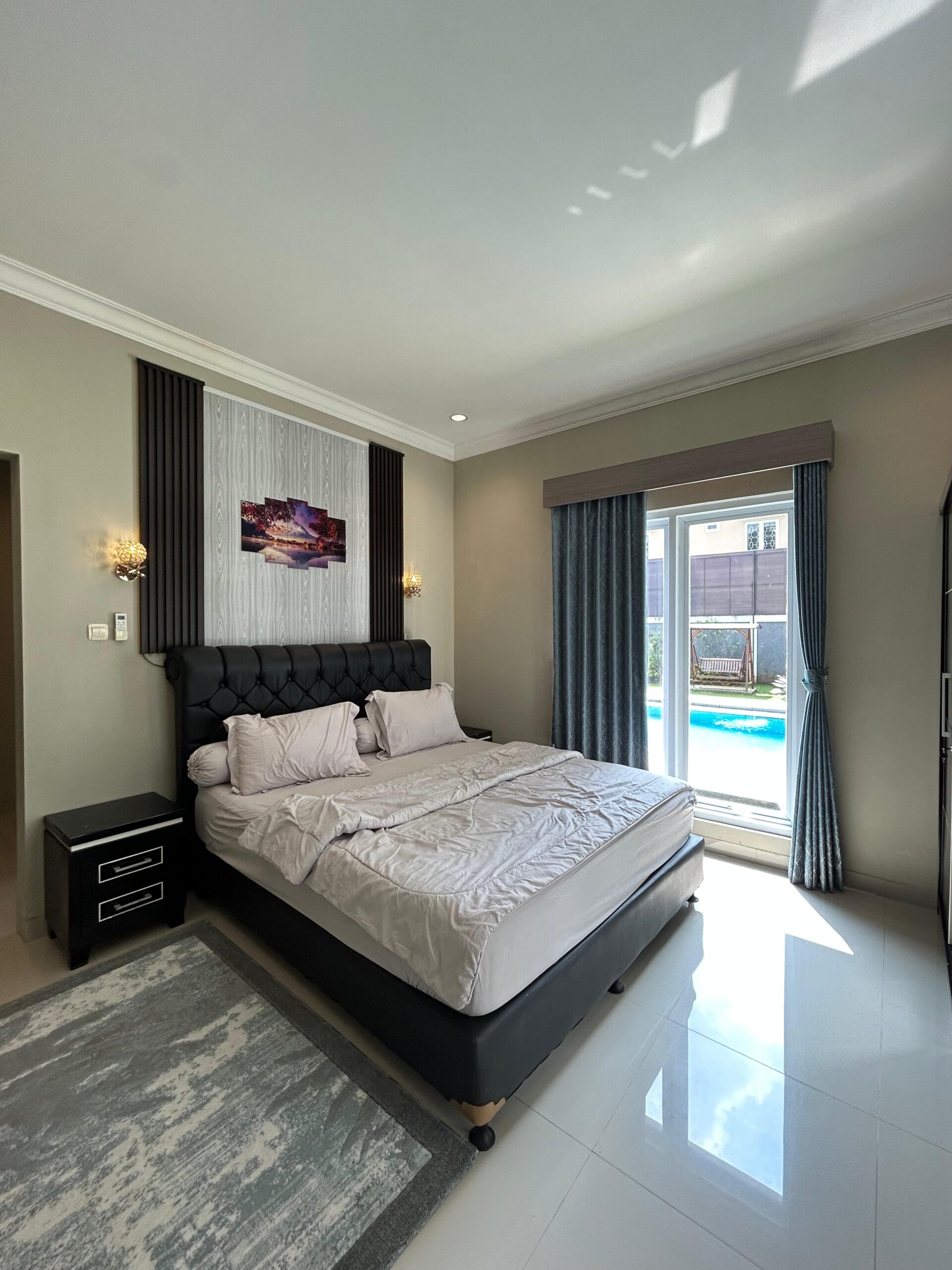 King bed with framed artwork and window