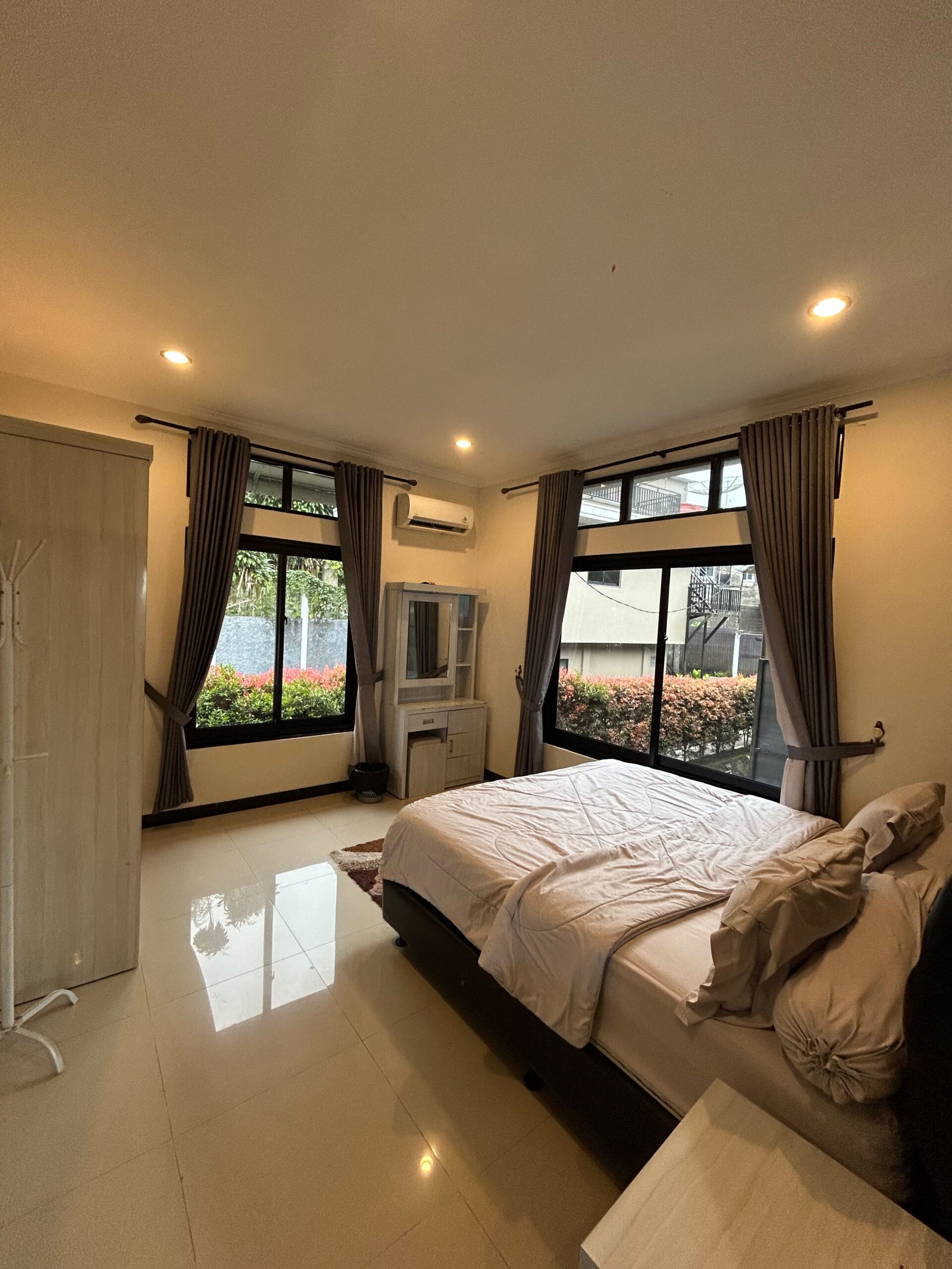 King bed with curtained windows and side table