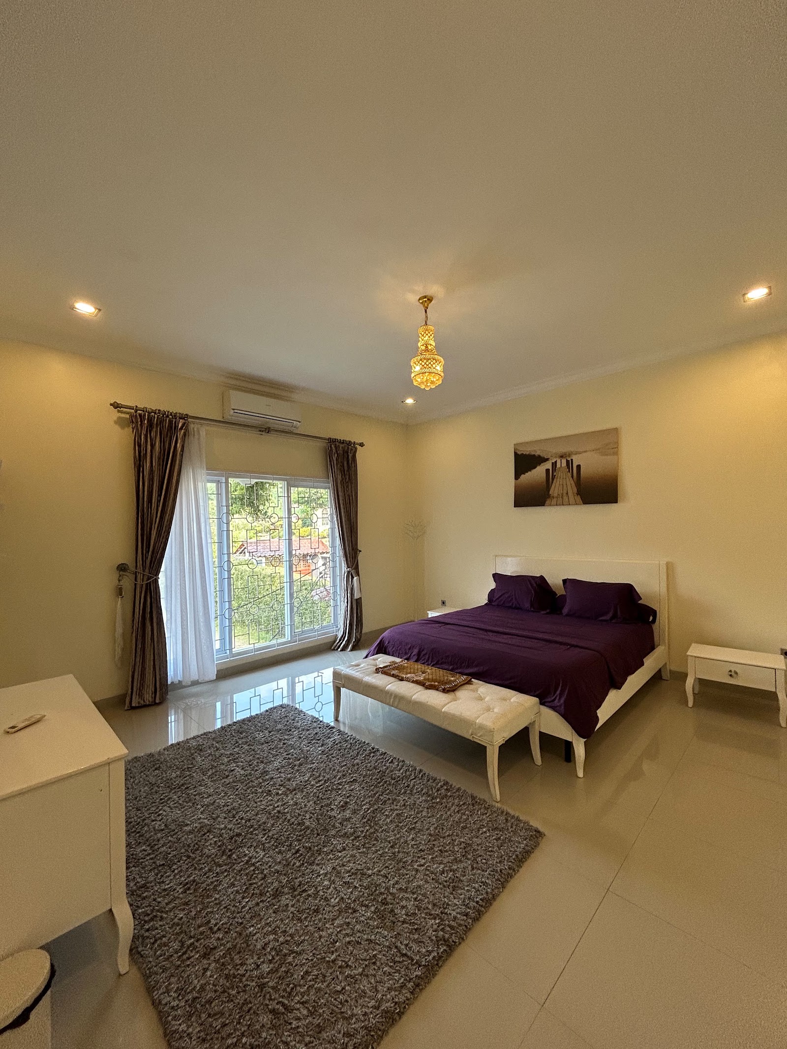 Bedroom with purple bedding and patterned rug, Al Andalus 1 Puncak