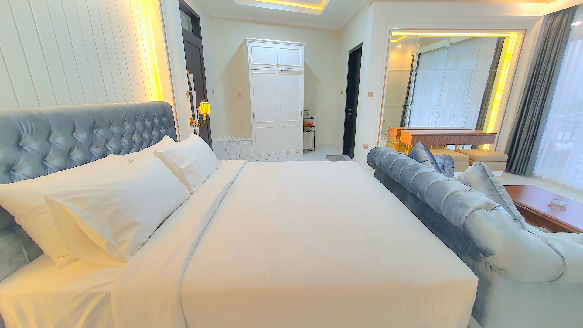 Bedroom with white bedding and blue cushions, Al Andalus Royal Puncak