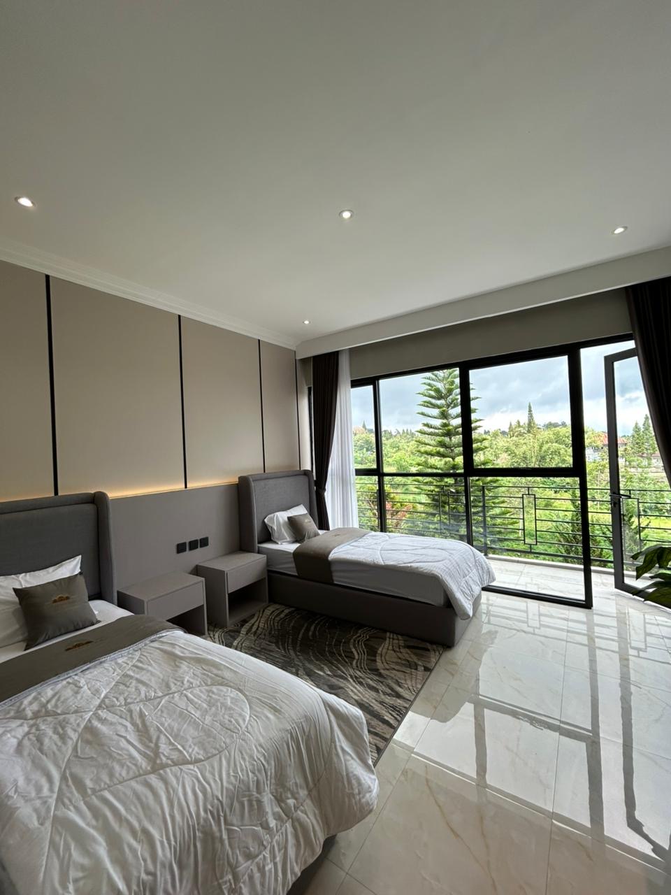 Twin-bed room opening to a window with green views