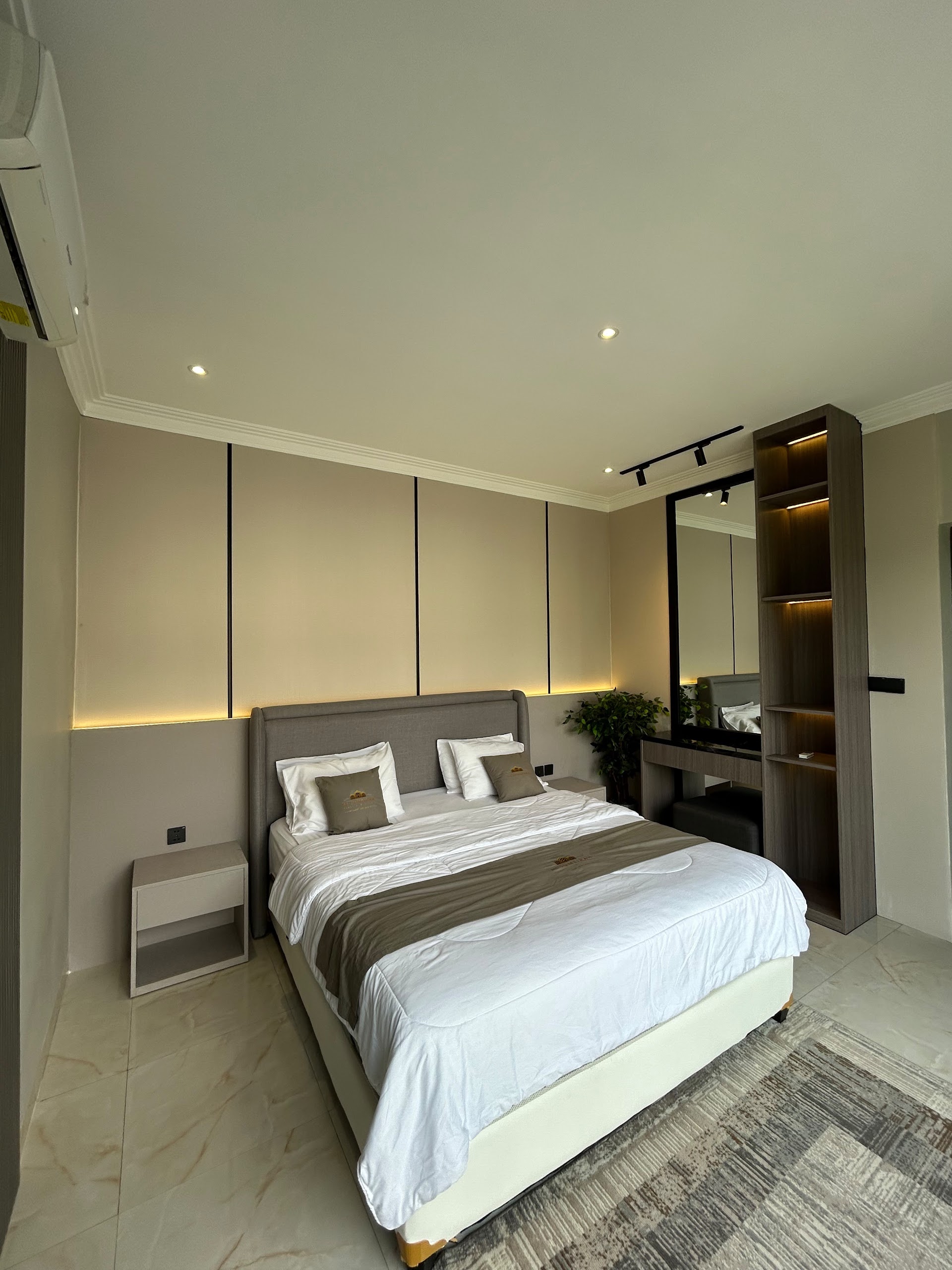 Double bedroom with dressing table and lit alcove shelving