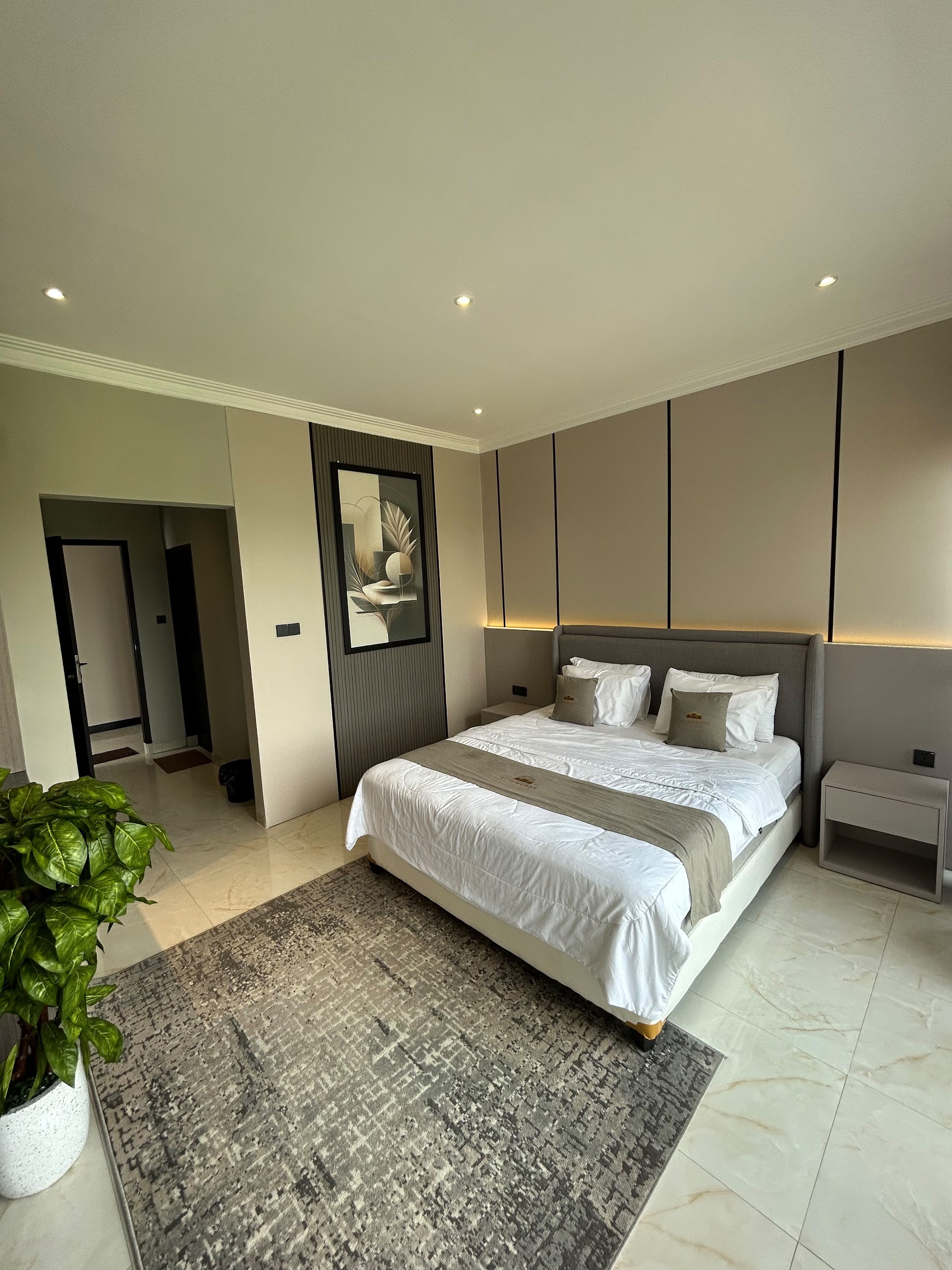 King bedroom with a timber headboard and bedside lamps