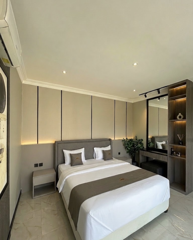 King bed with a mirrored wardrobe and lit alcove