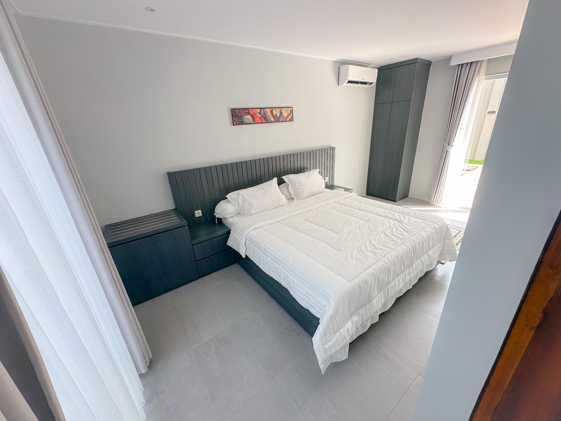 Bedroom with bed and curtained window at Armada Resort