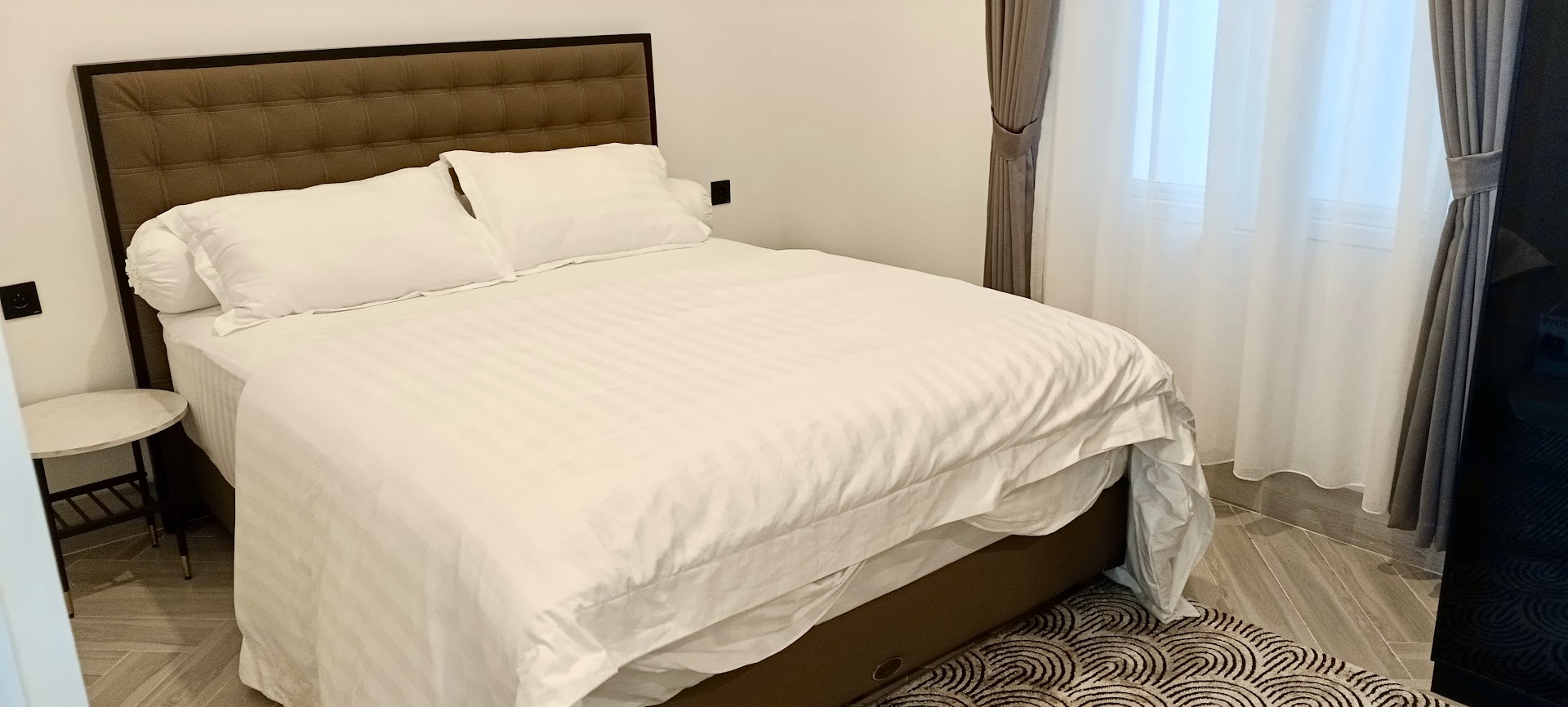 Bedroom with upholstered headboard and curtained window, Classic Resort Puncak